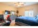 Comfortable bedroom with a ceiling fan and a view at 28136 N 90Th Ln, Peoria, AZ 85383