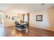 Formal dining area featuring wood floors, large table, rustic chandelier, and natural lighting at 28136 N 90Th Ln, Peoria, AZ 85383