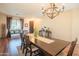 Traditional dining room with wood floors, chandelier, and large dining table with cactus decor at 28136 N 90Th Ln, Peoria, AZ 85383