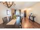 Bright dining area featuring a long wood table, chandelier, and a window bench at 28136 N 90Th Ln, Peoria, AZ 85383