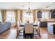 Open dining area featuring a chandelier, table with six chairs, and view to kitchen and living room at 28136 N 90Th Ln, Peoria, AZ 85383