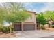 Lovely two-story home featuring a tile roof, desert landscaping, and a two-car garage at 28136 N 90Th Ln, Peoria, AZ 85383