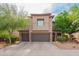 Delightful two-story home featuring a tile roof, desert landscaping, and a two-car garage at 28136 N 90Th Ln, Peoria, AZ 85383