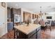 Cozy kitchen featuring gray cabinets, stainless steel appliances, quartz countertops, and laminate wood flooring at 28136 N 90Th Ln, Peoria, AZ 85383
