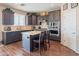 Inviting kitchen featuring gray cabinets, stainless appliances, quartz counters, and an island with seating at 28136 N 90Th Ln, Peoria, AZ 85383