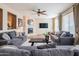 Spacious living room with stone fireplace, ceiling fan, and hardwood floors at 28136 N 90Th Ln, Peoria, AZ 85383