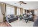 Inviting living room with hardwood floors, multiple couches, and natural light at 28136 N 90Th Ln, Peoria, AZ 85383