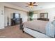 A spacious primary bedroom with cozy decor, a ceiling fan, and a dresser with an ornate mirror at 28136 N 90Th Ln, Peoria, AZ 85383