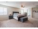 Large primary bedroom with a dark wood bed set, and carpet flooring, offering plenty of space to relax at 28136 N 90Th Ln, Peoria, AZ 85383