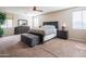Spacious primary bedroom with a dark wood furniture set and carpet floors, flooded with natural light at 28136 N 90Th Ln, Peoria, AZ 85383
