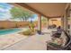 Covered patio with wicker seating and BBQ with backyard pool view at 28136 N 90Th Ln, Peoria, AZ 85383