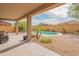 Covered patio with wicker seating and palm trees with backyard pool view at 28136 N 90Th Ln, Peoria, AZ 85383