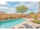 Backyard pool with patio, desert landscaping, privacy wall and blue sky at 28136 N 90Th Ln, Peoria, AZ 85383