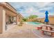 Inviting backyard featuring a refreshing pool, desert landscaping, and an outdoor dining area perfect for entertaining at 28136 N 90Th Ln, Peoria, AZ 85383