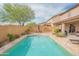 Backyard pool with patio table, palm trees and privacy wall at 28136 N 90Th Ln, Peoria, AZ 85383