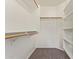 Walk-in closet with multiple shelves and rods for optimal storage solutions at 40427 N Orkney Way, San Tan Valley, AZ 85140