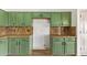 Stylish kitchen with custom green cabinets and granite countertops, offering ample storage and prep space at 40427 N Orkney Way, San Tan Valley, AZ 85140