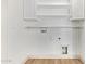 Laundry room featuring wood-look floors and white walls at 40427 N Orkney Way, San Tan Valley, AZ 85140