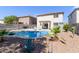 Private backyard with a refreshing pool, cozy patio seating, and easy-to-maintain desert landscaping at 4771 E Meadow Land Dr, San Tan Valley, AZ 85140