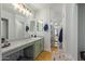 Bathroom with a large mirror, tiled floors, ample counter space, and convenient access to the hallway at 4771 E Meadow Land Dr, San Tan Valley, AZ 85140