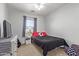 Bright bedroom with carpet, a gray curtained window, and a twin bed with a soccer-themed pillow at 4771 E Meadow Land Dr, San Tan Valley, AZ 85140