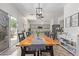 Bright dining room features a long wooden table and chairs, with open access to the kitchen at 4771 E Meadow Land Dr, San Tan Valley, AZ 85140