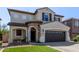 Inviting two-story home with an attractive stone-accented porch and a two-car garage at 4771 E Meadow Land Dr, San Tan Valley, AZ 85140
