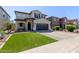 Lovely two-story home featuring a well-maintained lawn and an attached two-car garage at 4771 E Meadow Land Dr, San Tan Valley, AZ 85140