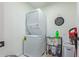 Compact laundry room equipped with a stacked washer and dryer, alongside shelving and storage solutions at 4771 E Meadow Land Dr, San Tan Valley, AZ 85140