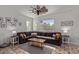 Comfortable living room features a large sectional sofa, ceiling fan, and bright natural light at 4771 E Meadow Land Dr, San Tan Valley, AZ 85140