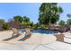 Backyard swimming pool with lounge chairs and mature trees at 4771 E Meadow Land Dr, San Tan Valley, AZ 85140