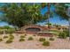 The Castlegate community entrance is adorned with landscaping, gravel, and lush foliage at 4771 E Meadow Land Dr, San Tan Valley, AZ 85140