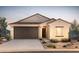 Inviting single-story home featuring a tile roof, two-car garage, and desert landscaping at 5023 S 252Nd Ave, Buckeye, AZ 85326