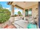 Covered back patio with comfortable seating and views of the beautifully landscaped backyard is great for entertaining at 660 W Twin Peaks Pkwy, San Tan Valley, AZ 85143
