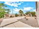 Well-maintained backyard with desert landscaping, gravel, concrete pads, and seating areas for relaxing outdoors at 660 W Twin Peaks Pkwy, San Tan Valley, AZ 85143