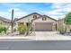 Charming single-story home featuring a two-car garage, desert landscaping, and a neutral color palette at 660 W Twin Peaks Pkwy, San Tan Valley, AZ 85143