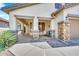 Inviting front porch showcasing stone pillars, desert plants, and a seating area, enhancing curb appeal at 660 W Twin Peaks Pkwy, San Tan Valley, AZ 85143