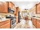 Functional kitchen with stainless steel appliances, warm wood cabinets, and a breakfast nook at 660 W Twin Peaks Pkwy, San Tan Valley, AZ 85143