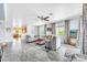 Open-concept living room with hardwood floors and large windows, providing a bright and airy feel at 660 W Twin Peaks Pkwy, San Tan Valley, AZ 85143