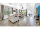 Spacious living room with hardwood floors, a ceiling fan, and lots of natural light at 660 W Twin Peaks Pkwy, San Tan Valley, AZ 85143