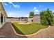 A backyard featuring artificial grass, a brick paver border and gravel at 701 S 92Nd St, Mesa, AZ 85208