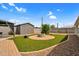 A backyard featuring artificial grass, a brick paver border and gravel at 701 S 92Nd St, Mesa, AZ 85208