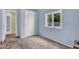 This bedroom features a double door closet, tan carpet and blue walls at 701 S 92Nd St, Mesa, AZ 85208