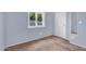Light blue bedroom features neutral carpeting, a large window, and a closet at 701 S 92Nd St, Mesa, AZ 85208