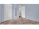 Light blue bedroom features neutral carpeting, an open closet, and natural light at 701 S 92Nd St, Mesa, AZ 85208