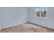Light blue bedroom features neutral carpeting and a bright window view at 701 S 92Nd St, Mesa, AZ 85208