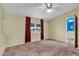 Neutral primary bedroom features ceiling fan, plush carpeting, and bathroom access at 701 S 92Nd St, Mesa, AZ 85208
