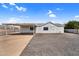 Exterior of a single-story home with a covered carport and low-maintenance gravel landscaping, providing a clean and simple design at 701 S 92Nd St, Mesa, AZ 85208