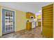 Cozy eat-in kitchen with warm yellow accents, white appliances, and a view of the front door providing a practical space at 701 S 92Nd St, Mesa, AZ 85208