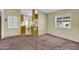 Inviting living space with plush carpeting and views into the kitchen, offering a comfortable and connected home environment at 701 S 92Nd St, Mesa, AZ 85208